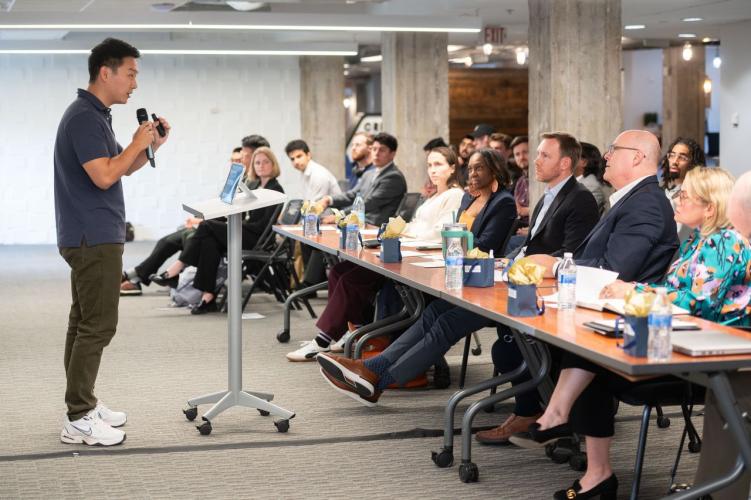 Man pitches to group at table